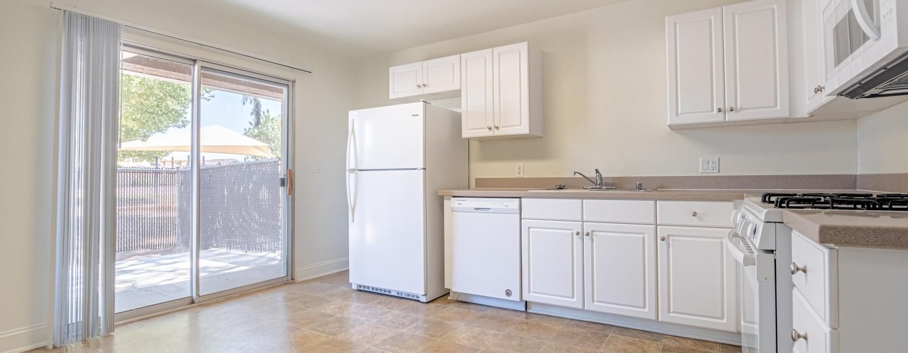 a kitchen with white cabinets