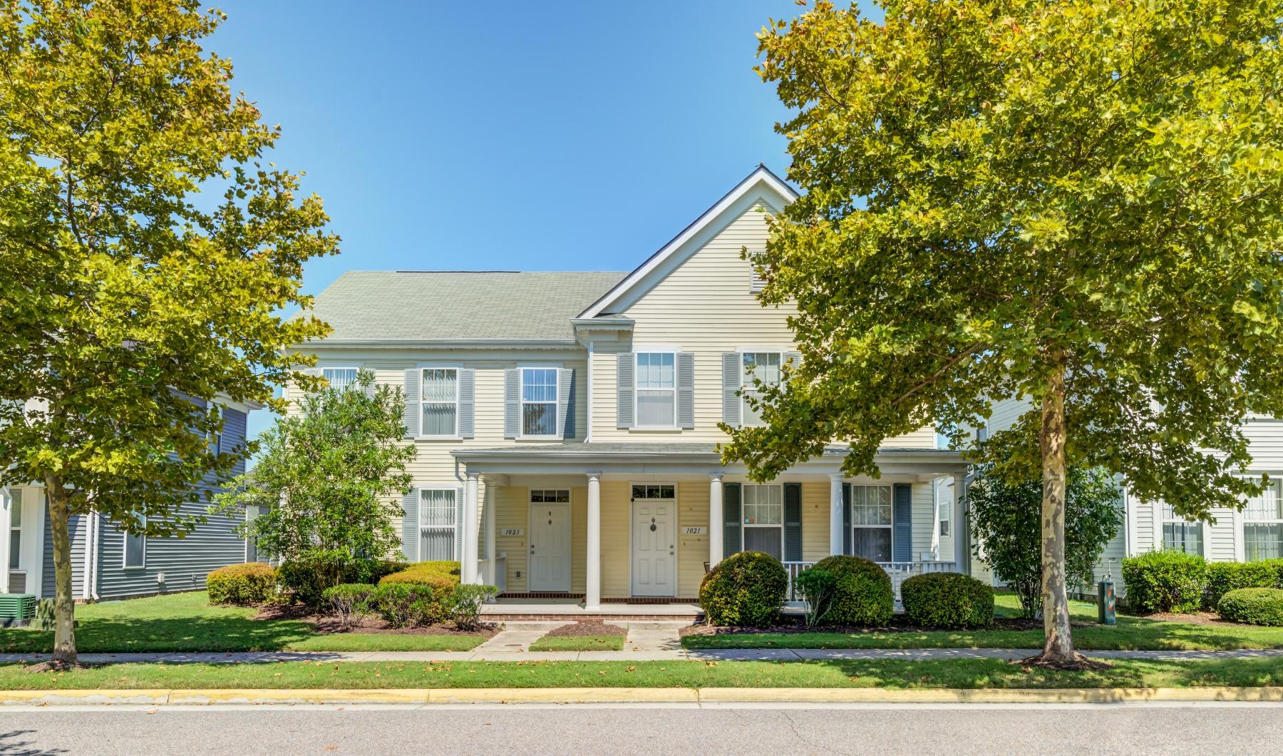 a large house with trees in front