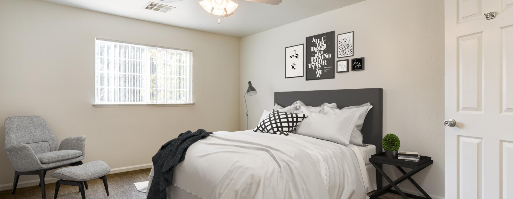 a bedroom with a bed and a fan