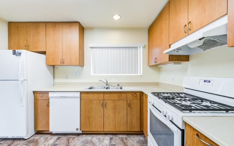 a kitchen with wooden cabinets
