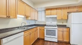 a kitchen with wooden cabinets