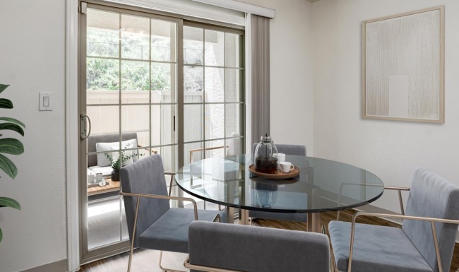 dining area with a table and chairs next to a glass door