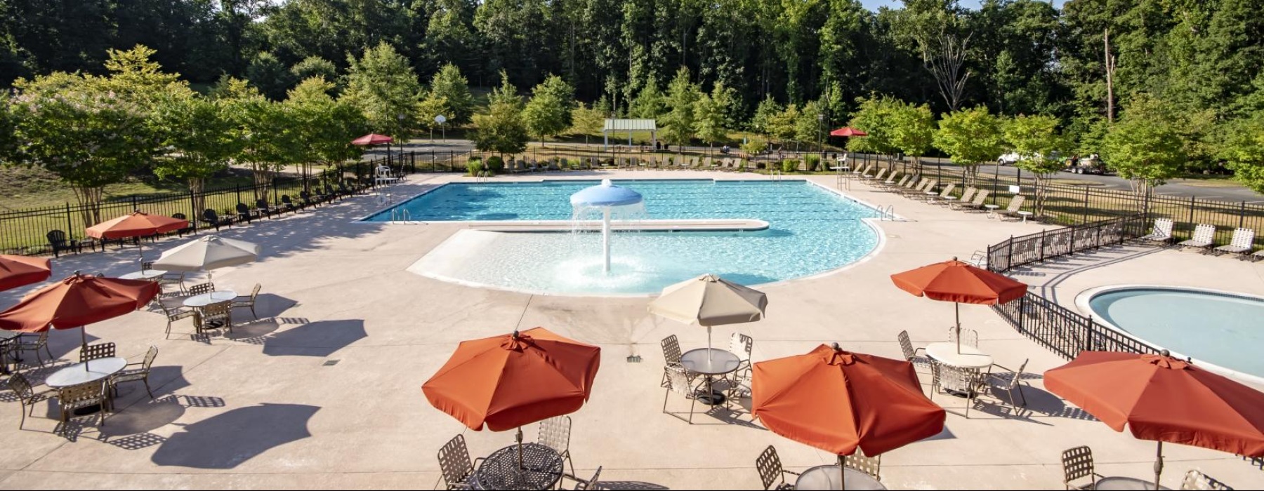 a pool with umbrellas and chairs next to it