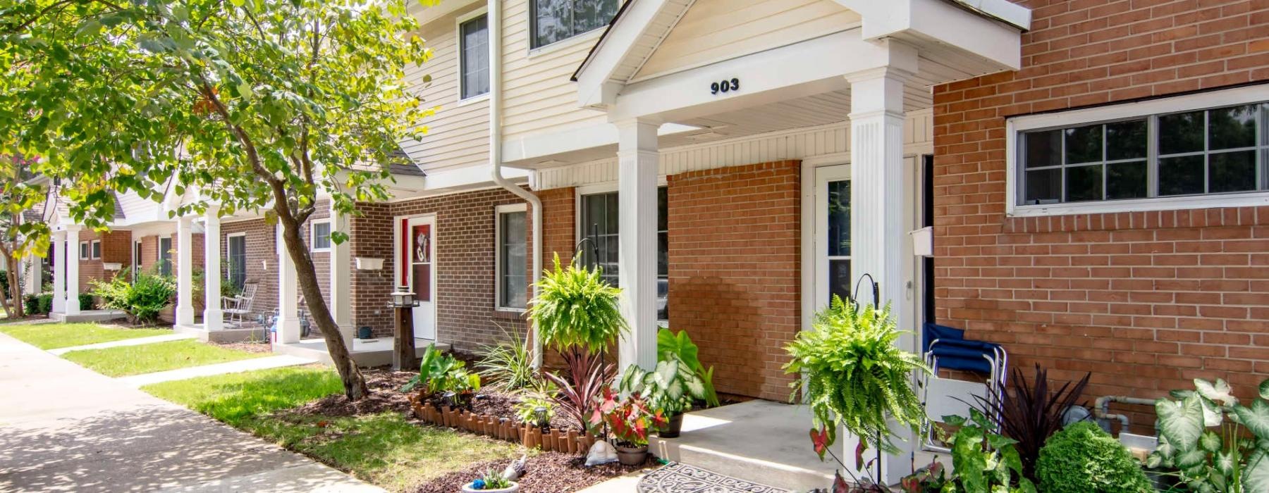 a brick building with a small garden