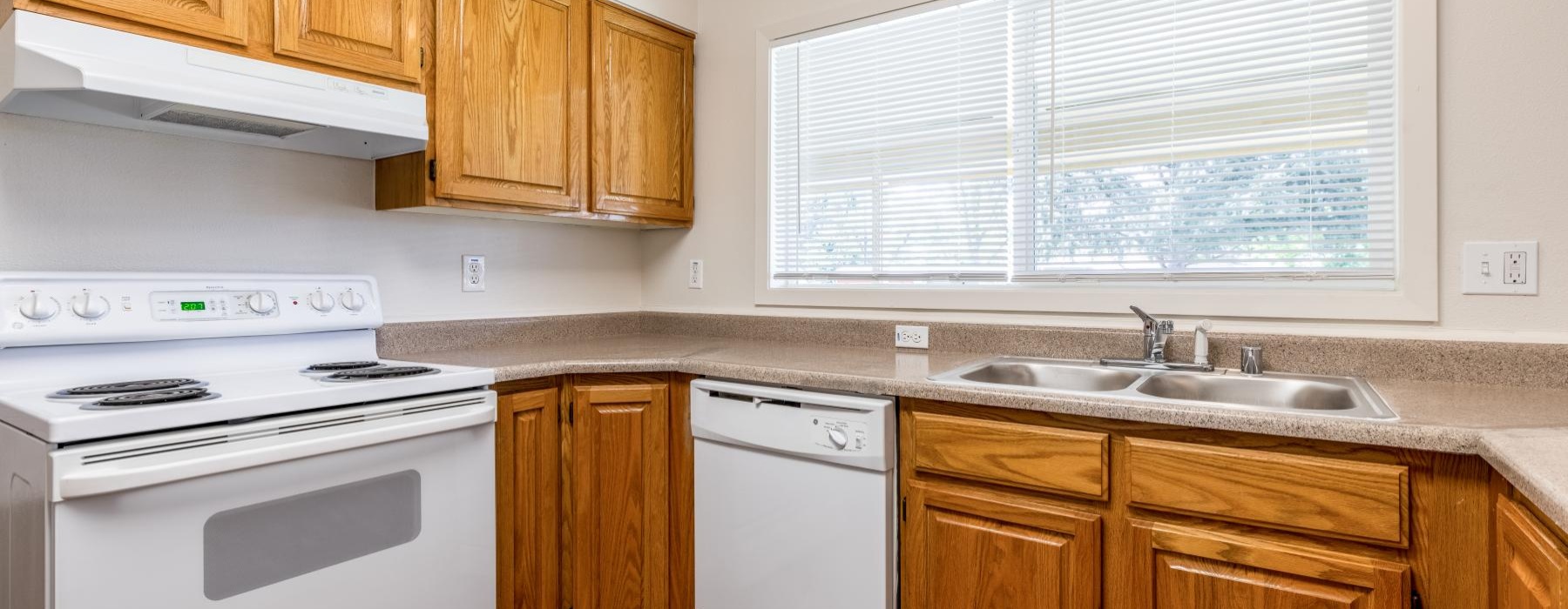 a kitchen with wooden cabinets