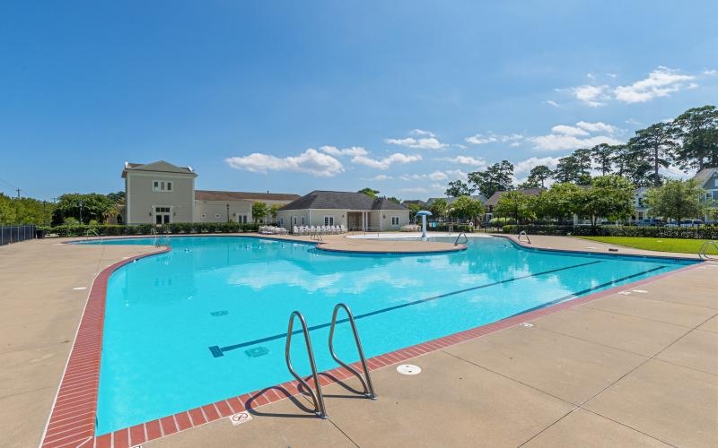 Resort-style swimming pool with lounge seating
