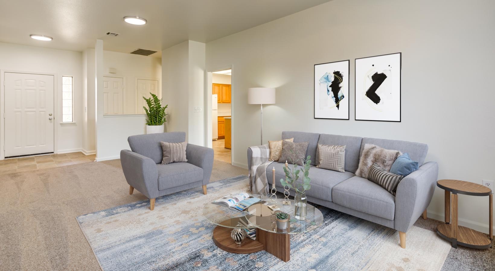 a living room with a couch and a fan