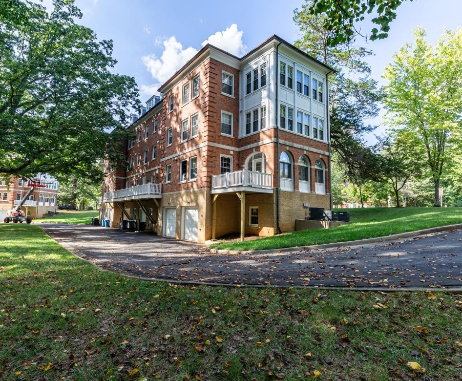 a large building with trees and grass