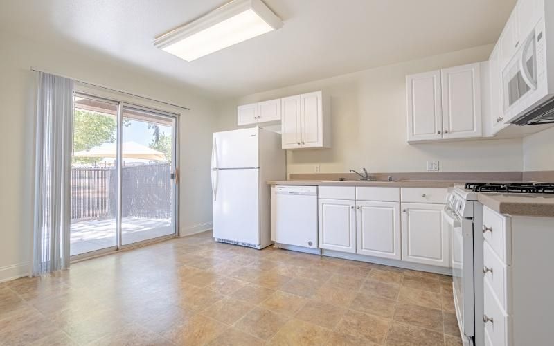 a kitchen with white cabinets