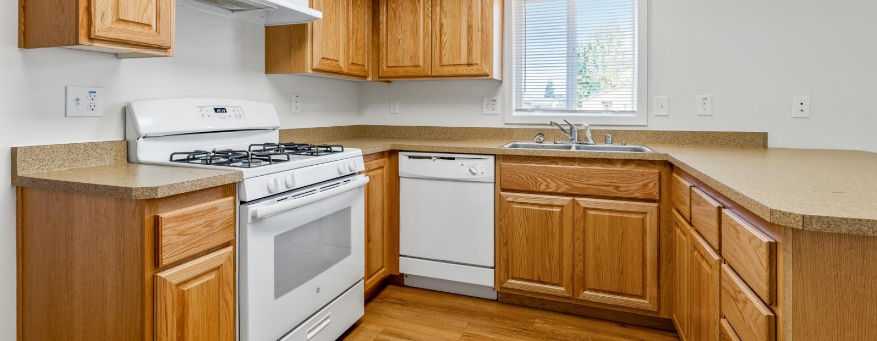a kitchen with wooden cabinets