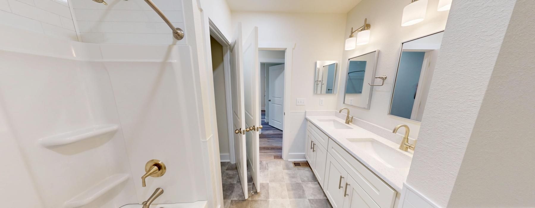 a bathroom with a walk-in shower, sink, and mirror