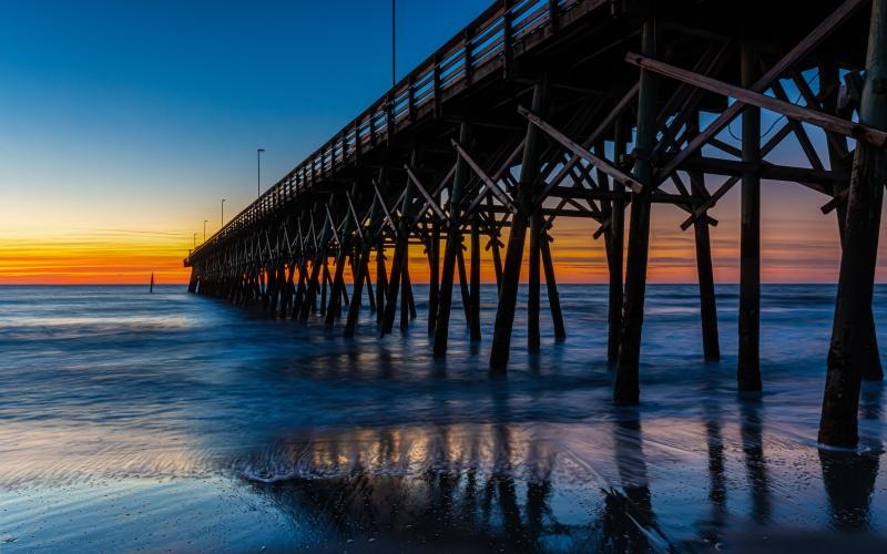 a long wooden bridge over water
