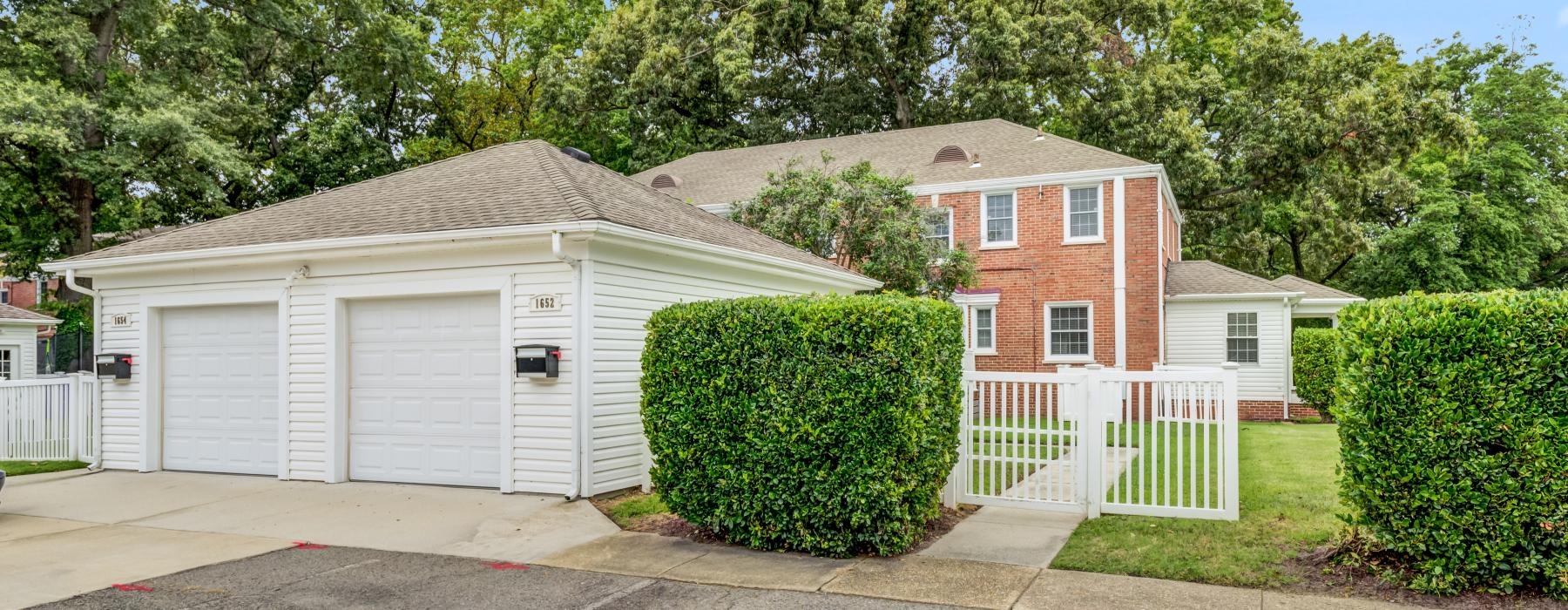 a house with a garage and bushes