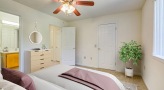 a bedroom with a fan and a bed