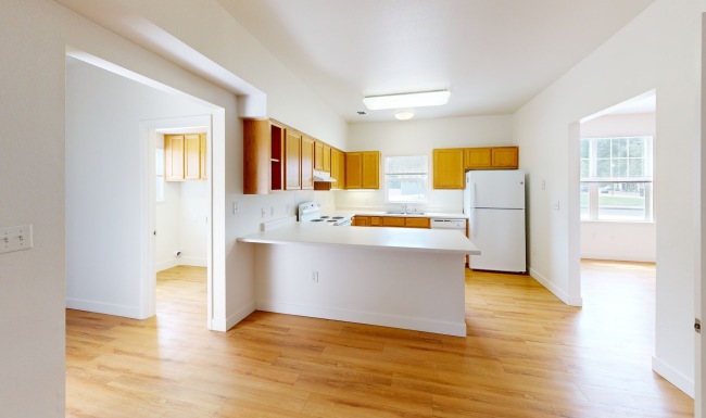 kitchen with wooden cabinets and white appliances