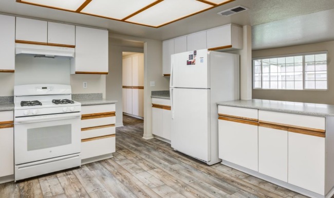 a kitchen with white cabinets
