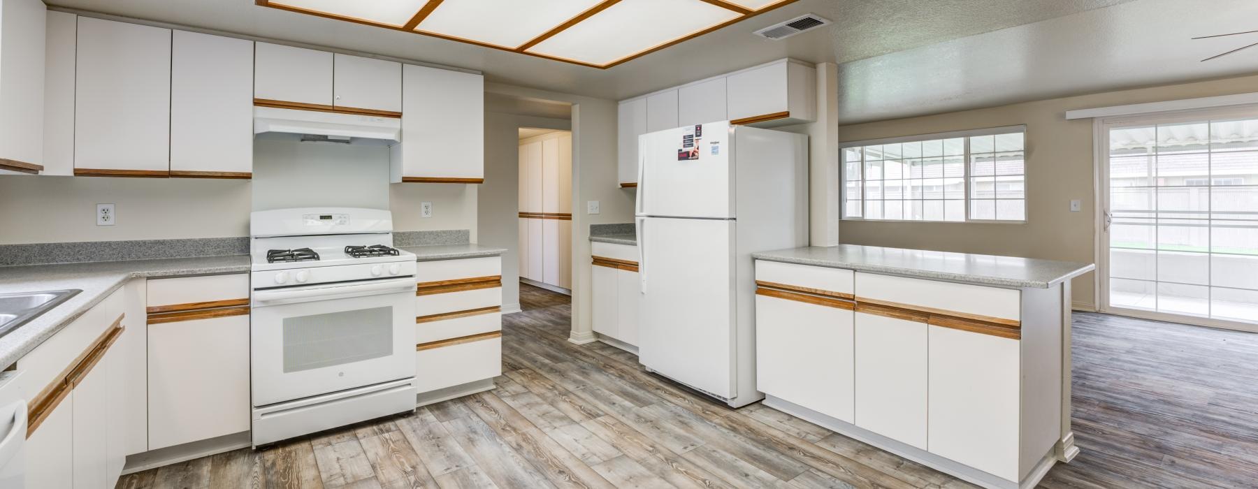 a kitchen with white cabinets