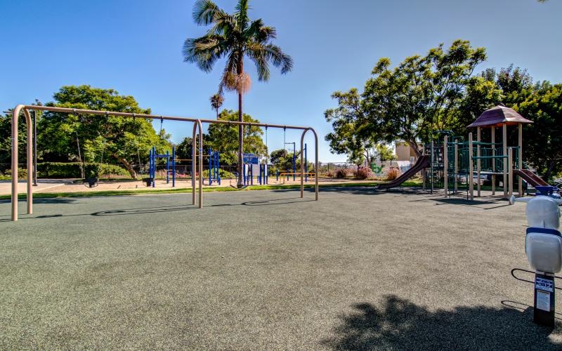 a playground with trees and a slide