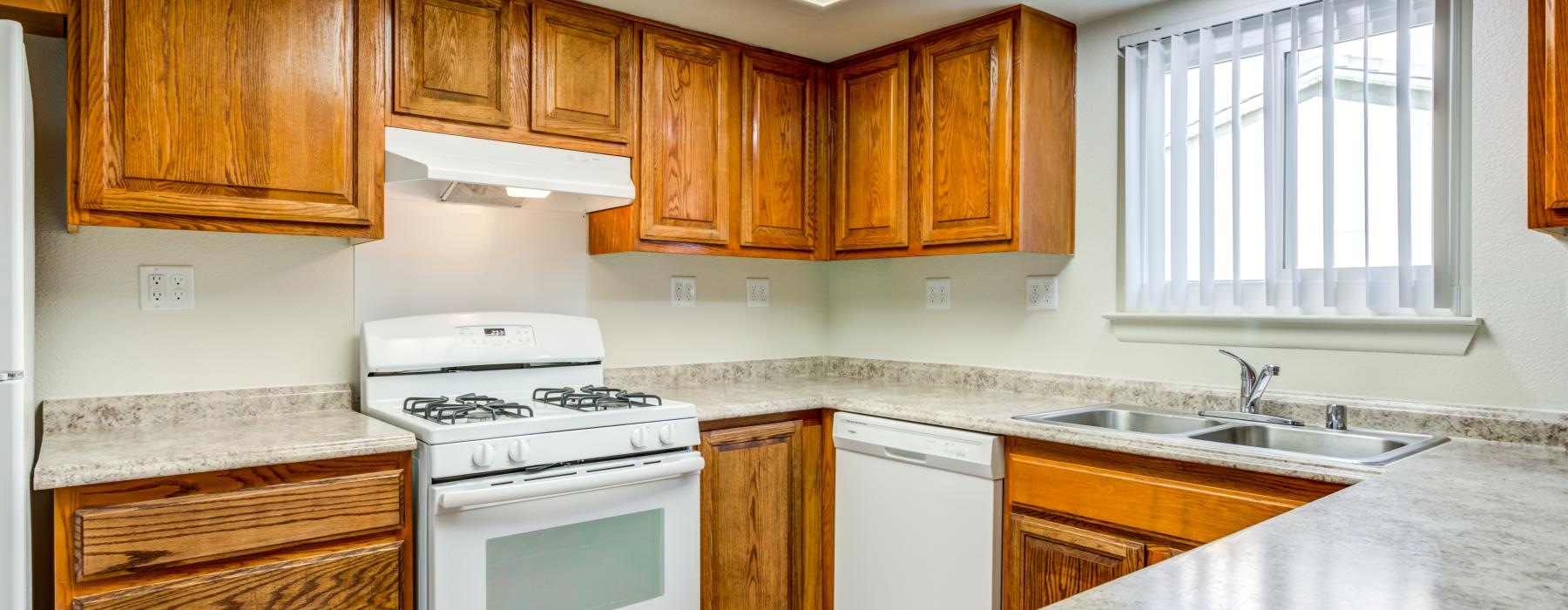 a kitchen with wooden cabinets