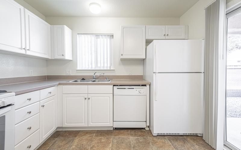 a kitchen with white cabinets