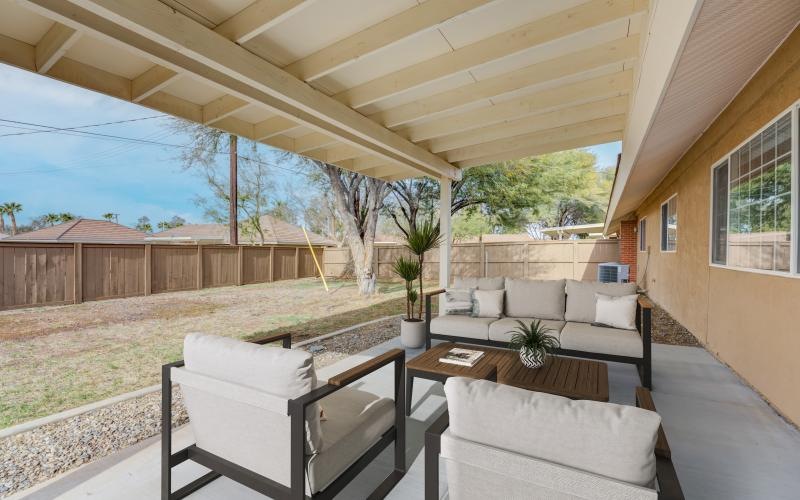 a patio with a table and chairs