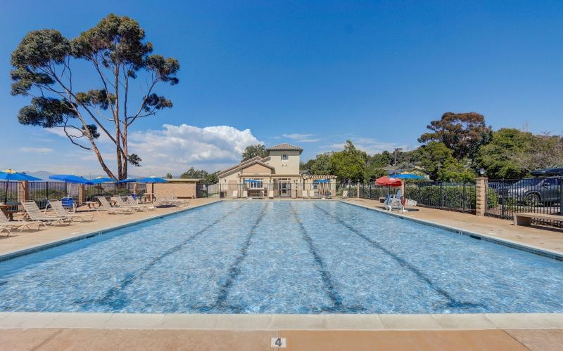 a swimming pool with a building in the background