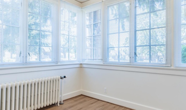 a room with a wood floor and windows