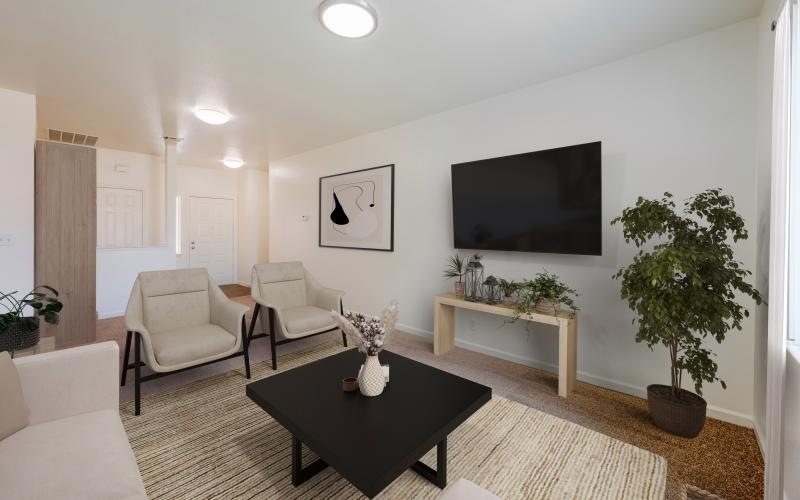 a living room with a tv and chairs