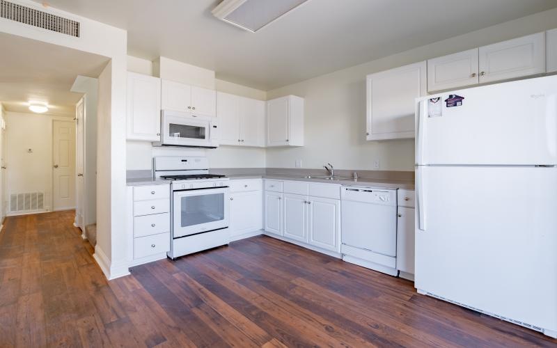 a kitchen with white cabinets