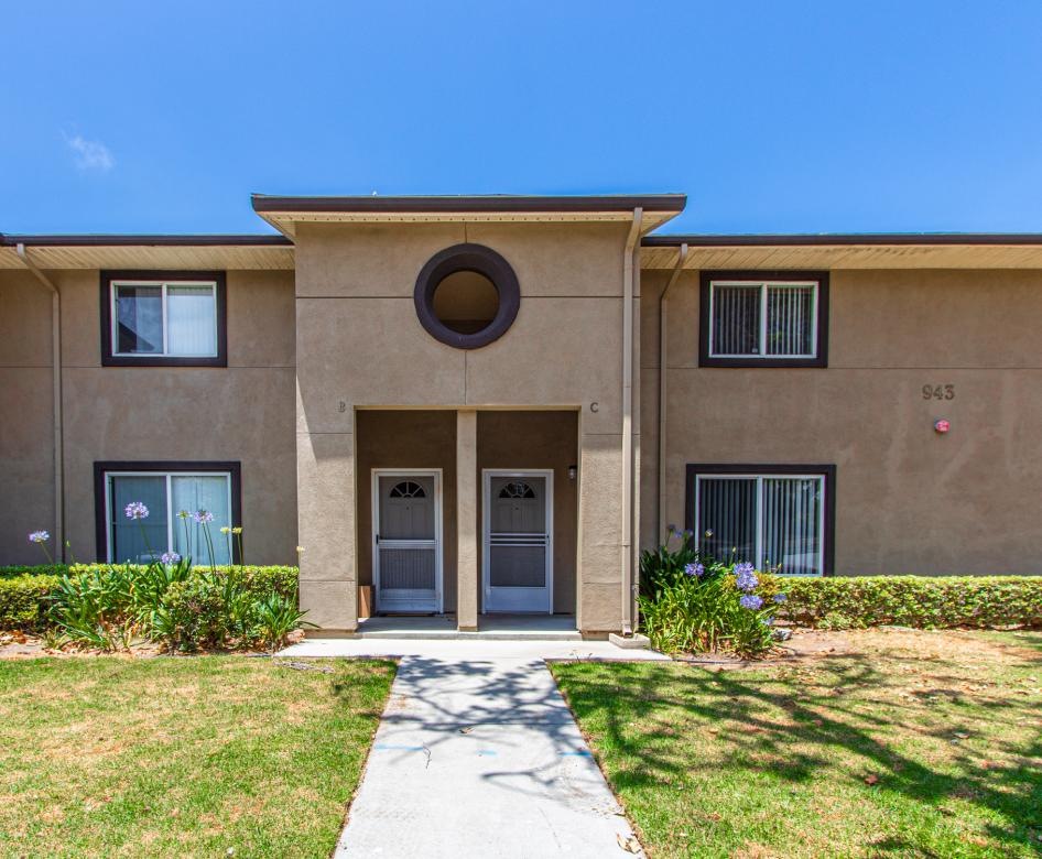 a building with a walkway and grass