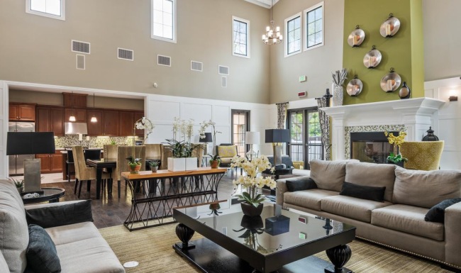a large living room with a piano