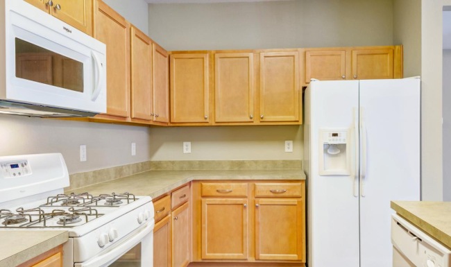 a kitchen with wooden cabinets