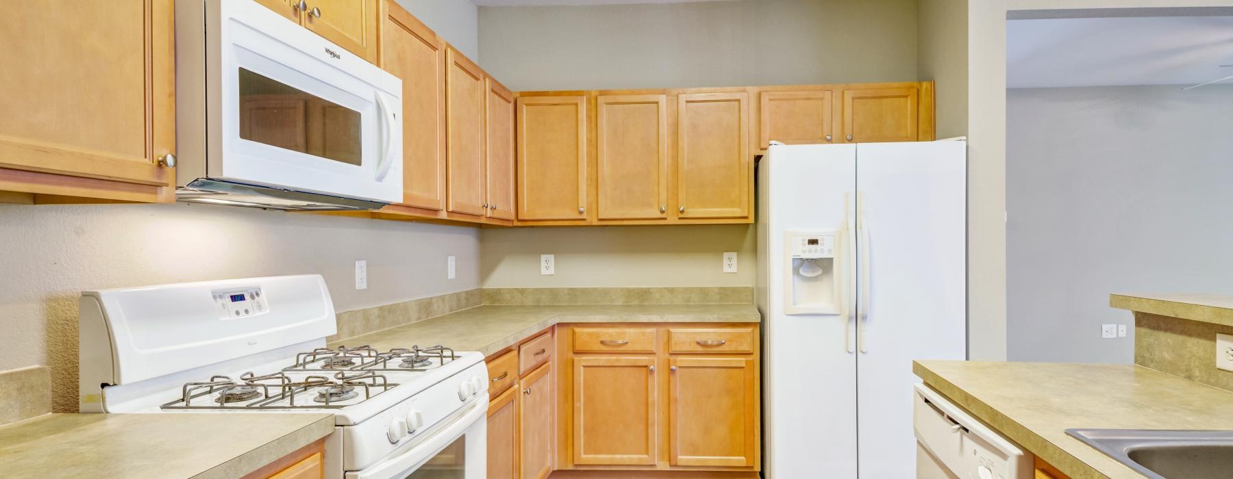 a kitchen with wooden cabinets