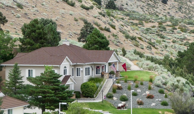 a building with trees and hills in the background