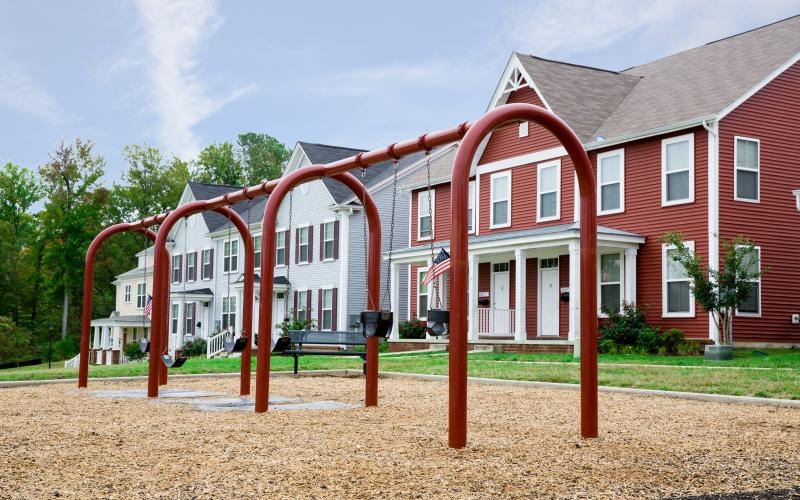 a red building with a swing in front of it