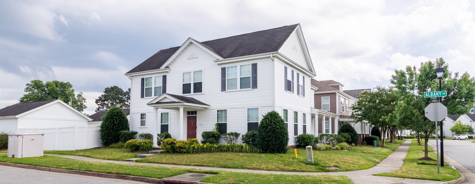 a house on a corner with a large lawn