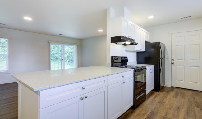 a kitchen with white cabinets