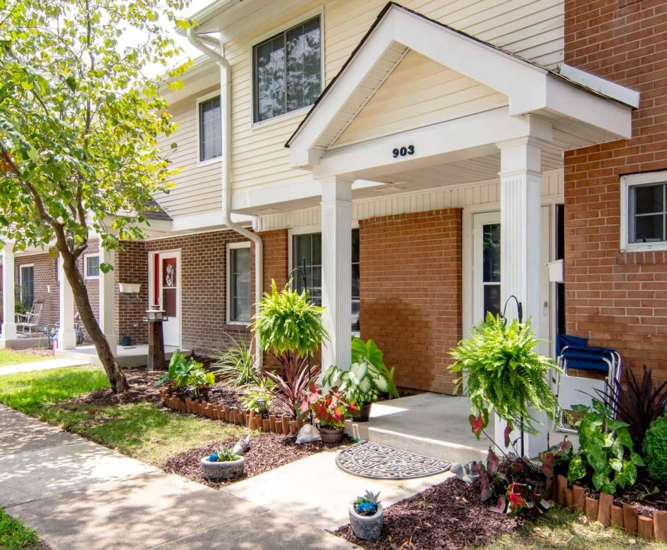 a brick building with a small garden